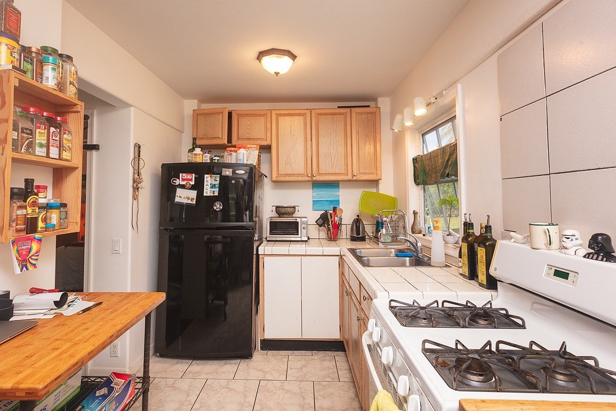 5851 Lokelani Road Kapaa, HI 96746 - Photo 16 of 21 a kitchen with stainless steel appliances granite countertop a refrigerator stove and sink