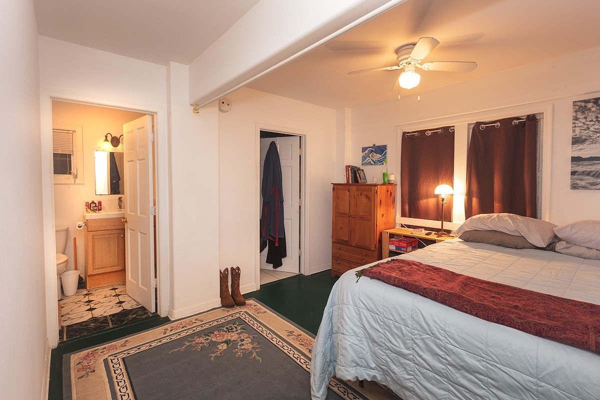 5851 Lokelani Road Kapaa, HI 96746 - Photo 17 of 21 a bedroom with a bed and a chandelier