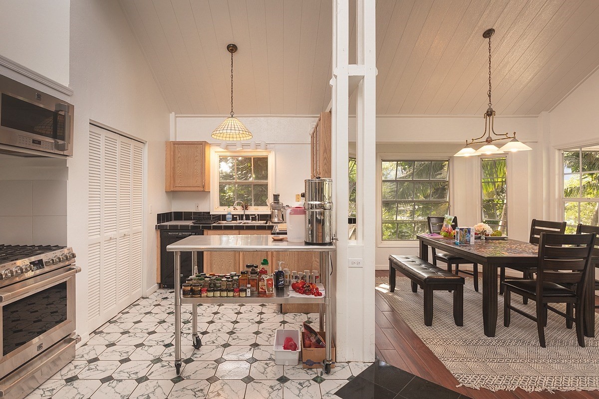 5851 Lokelani Road Kapaa, HI 96746 - Photo 3 of 21 a kitchen with stainless steel appliances kitchen island granite countertop a stove a sink and a refrigerator