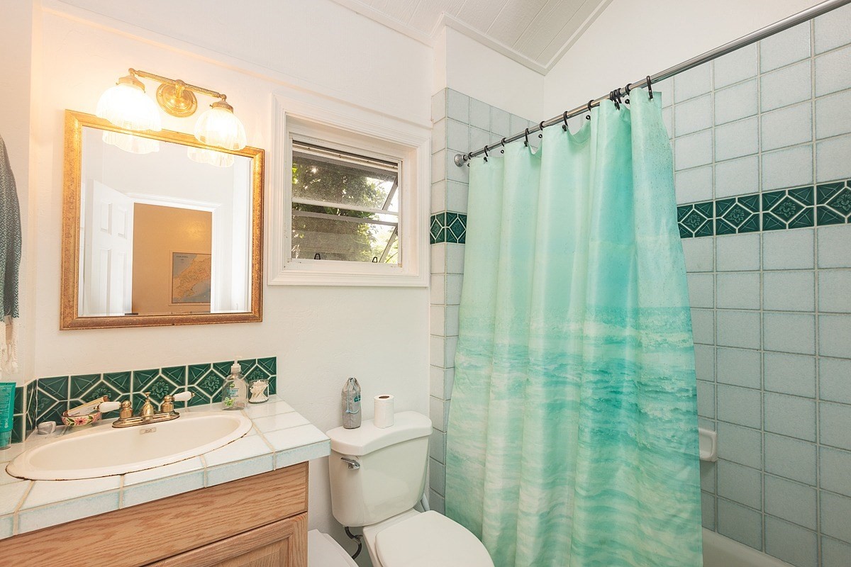 5851 Lokelani Road Kapaa, HI 96746 - Photo 7 of 21 a bathroom with a granite countertop toilet sink and mirror