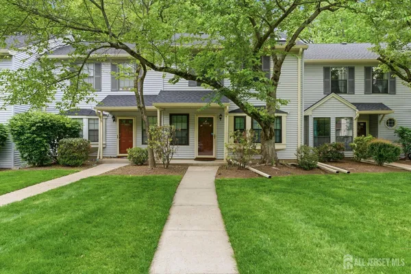a front view of a house with yard patio and green space