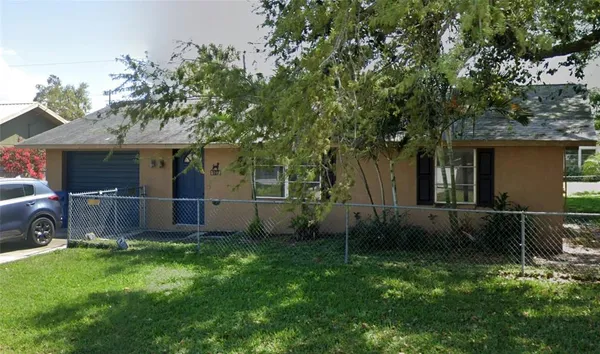 a view of backyard of house with green space