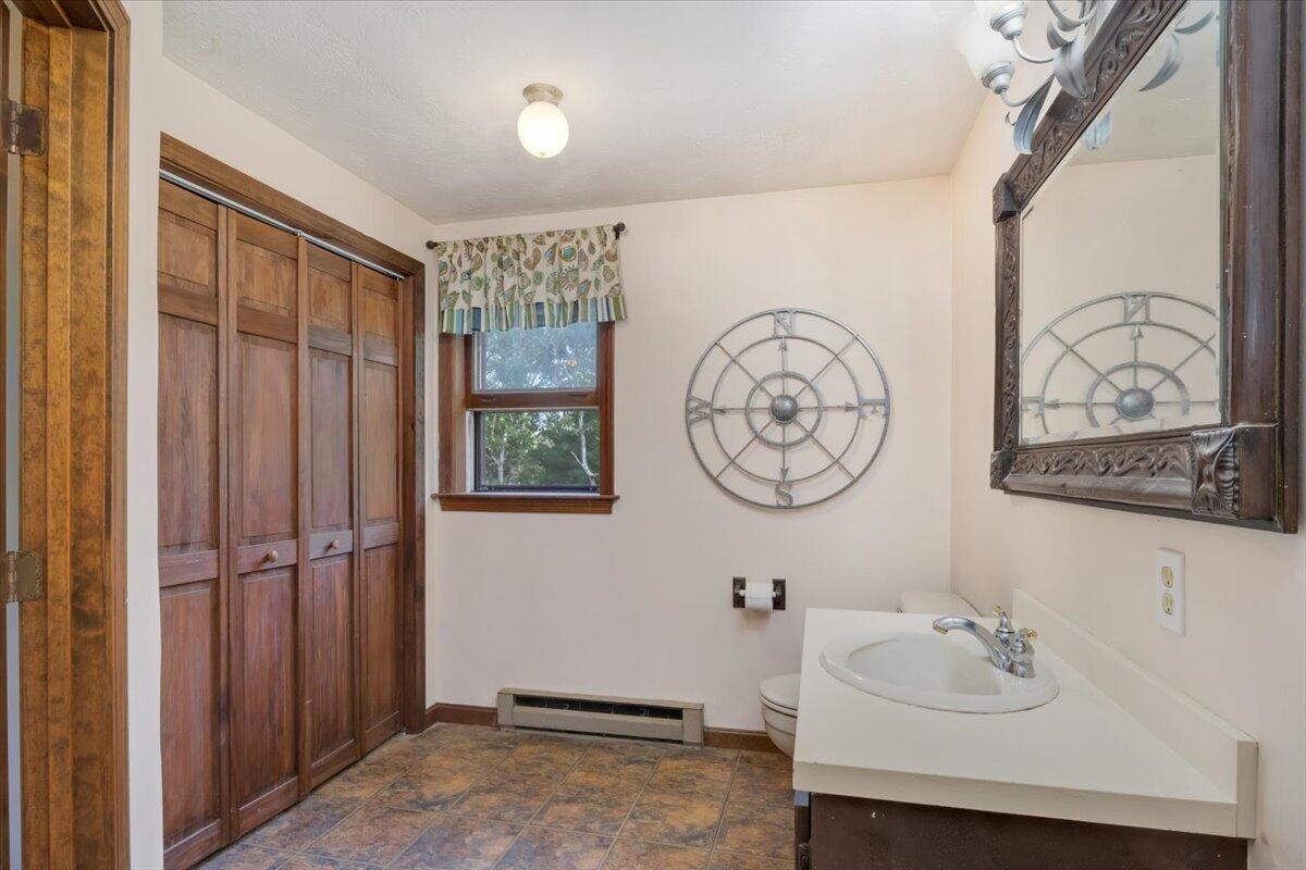 41 Service Road East Sandwich, MA 02537 - Photo 17 of 38 a bathroom with a sink and a mirror