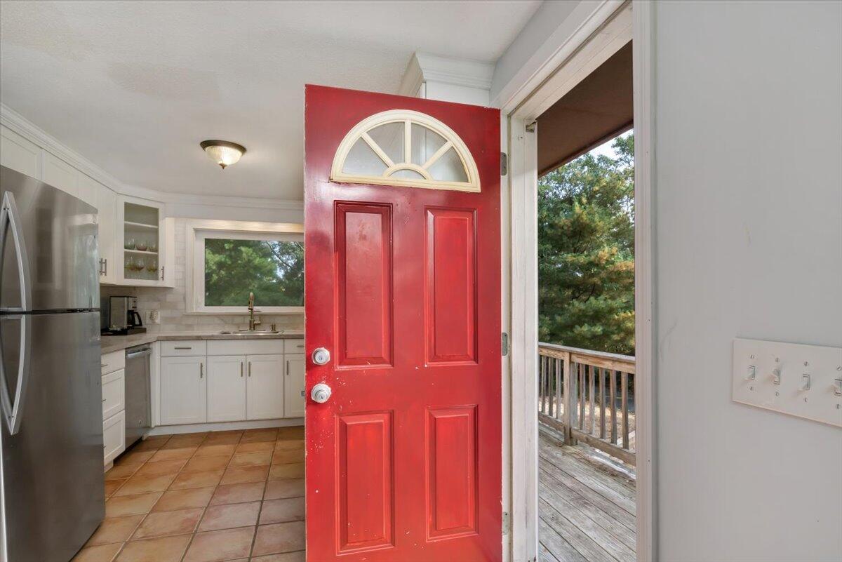 41 Service Road East Sandwich, MA 02537 - Photo 3 of 38 a kitchen with a refrigerator a sink dishwasher and wooden cabinets with a large window