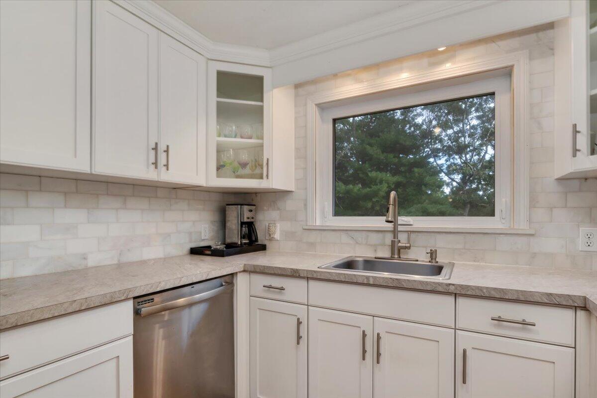 41 Service Road East Sandwich, MA 02537 - Photo 6 of 38 a kitchen with stainless steel appliances white cabinets a window and a sink