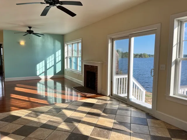 a view of a livingroom with furniture ceiling fan and window