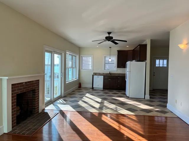 a view of a kitchen with a stove cabinets and wooden floor