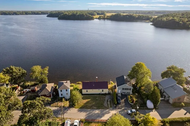 a room with lots of flower plants and water view