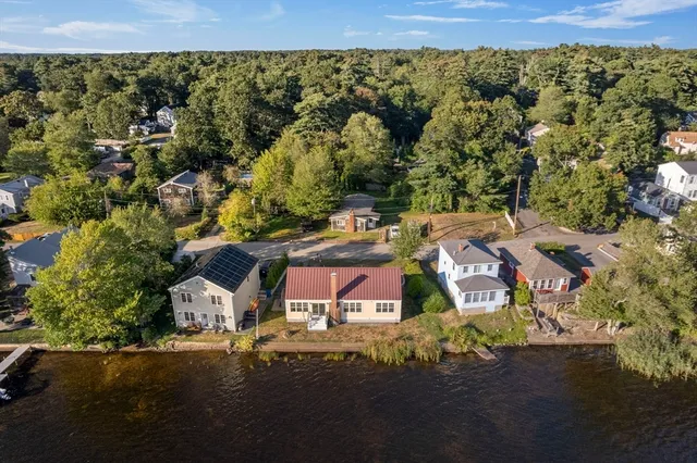 an aerial view of residential houses with outdoor space and street view