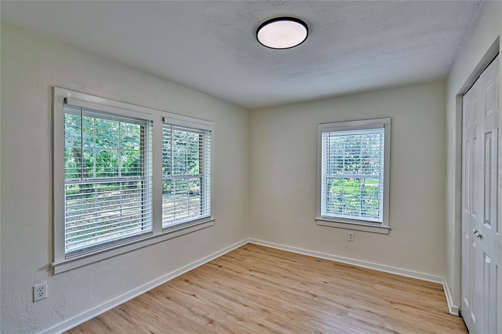 209 Southeast 47th Street Gainesville, FL 32641 - Photo 19 of 29 a view of an empty room with wooden floor and a window