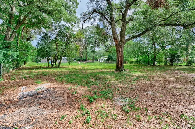 a front view of a house with a garden and yard