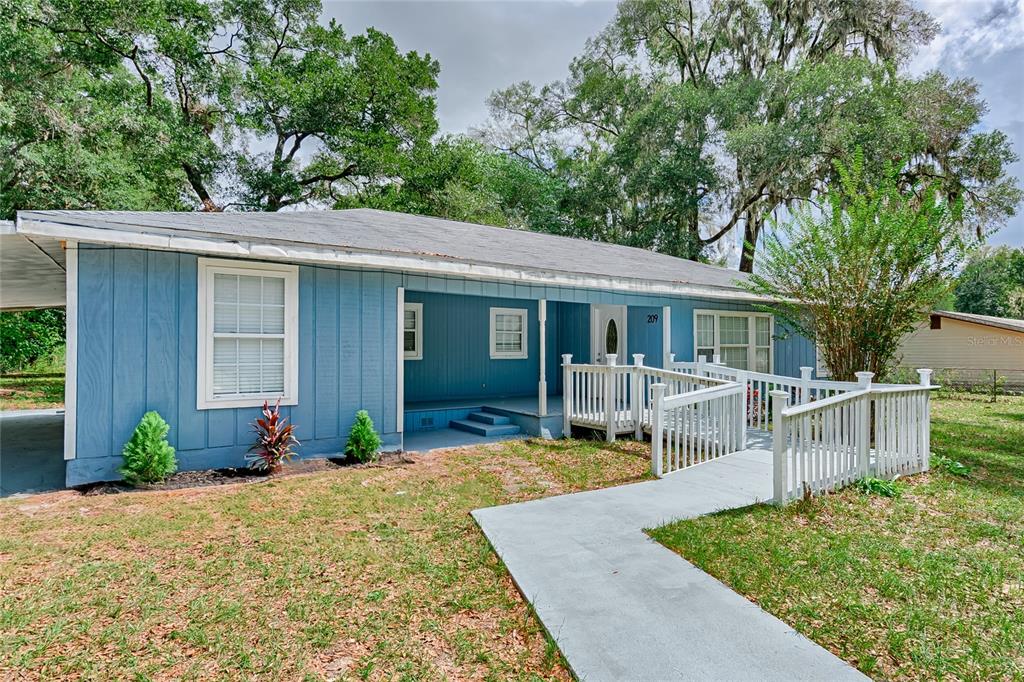 209 Southeast 47th Street Gainesville, FL 32641 - Photo 23 of 29 front view of a house with a patio