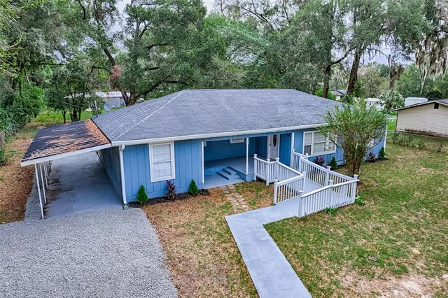 an aerial view of a house with yard and outdoor space