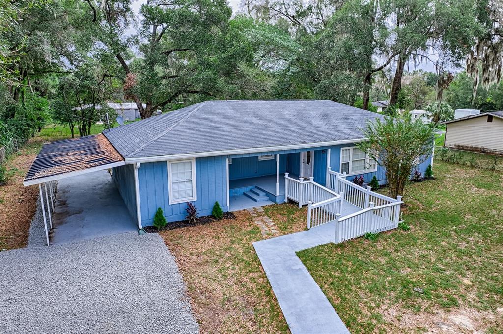 209 Southeast 47th Street Gainesville, FL 32641 - Photo 25 of 29 a view of a house with a yard potted plants and large tree