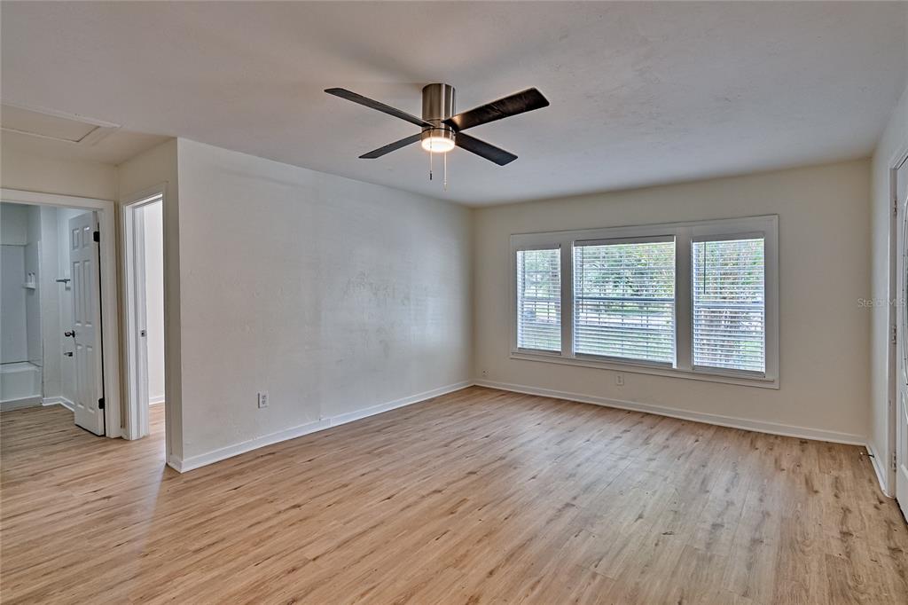 209 Southeast 47th Street Gainesville, FL 32641 - Photo 4 of 29 a view of empty room with wooden floor and fan
