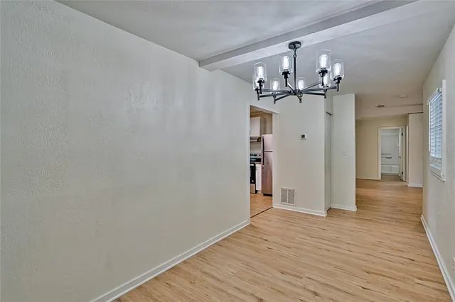 a dining room with furniture a chandelier and window