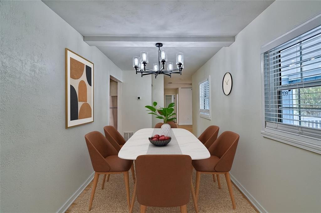 209 Southeast 47th Street Gainesville, FL 32641 - Photo 7 of 29 a dining room with furniture a chandelier and window