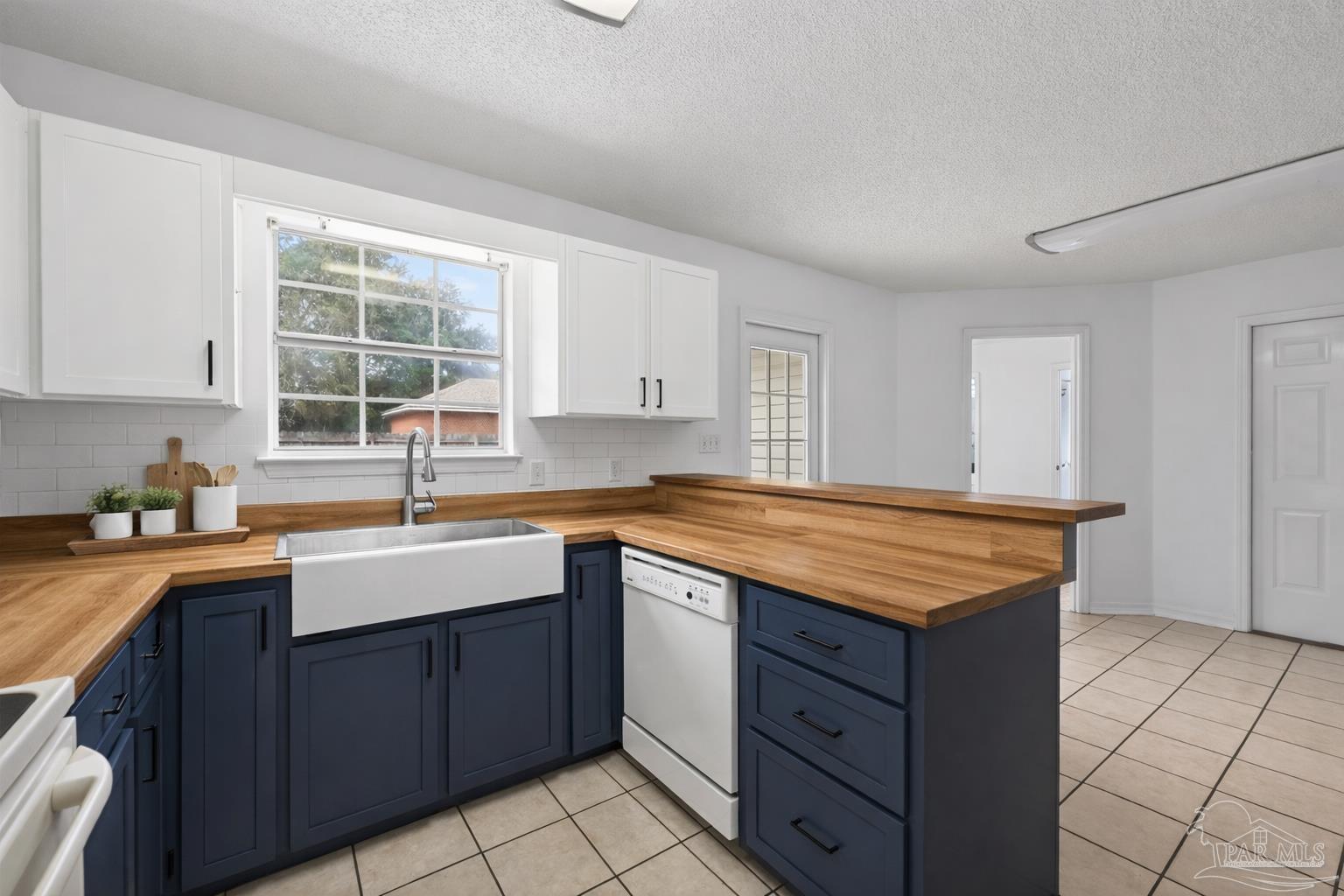 4885 Mayo Circle Pace, FL 32571 - Photo 11 of 44 a kitchen with a sink stove and cabinets