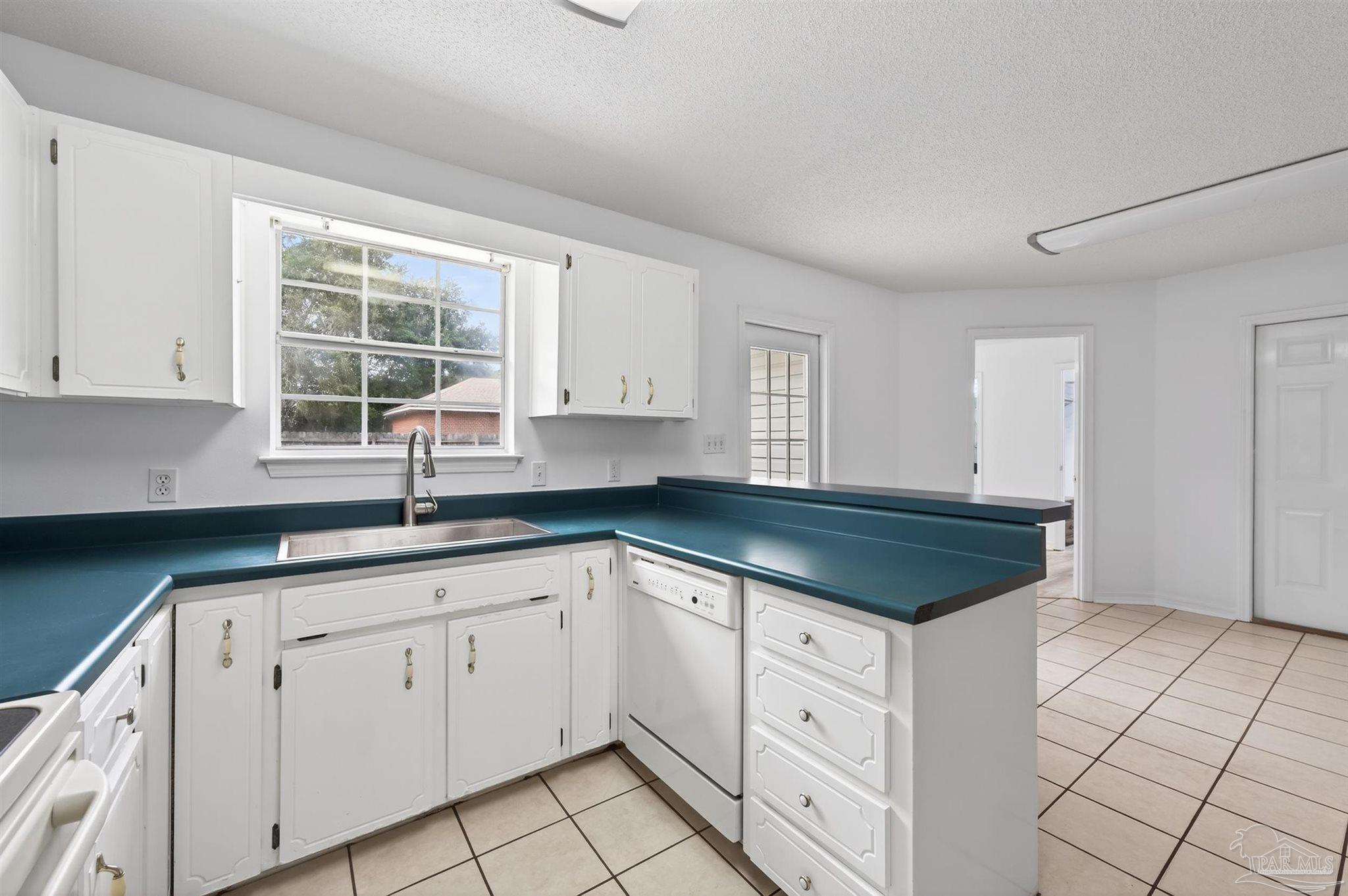4885 Mayo Circle Pace, FL 32571 - Photo 12 of 44 a kitchen with granite countertop white cabinets and a sink
