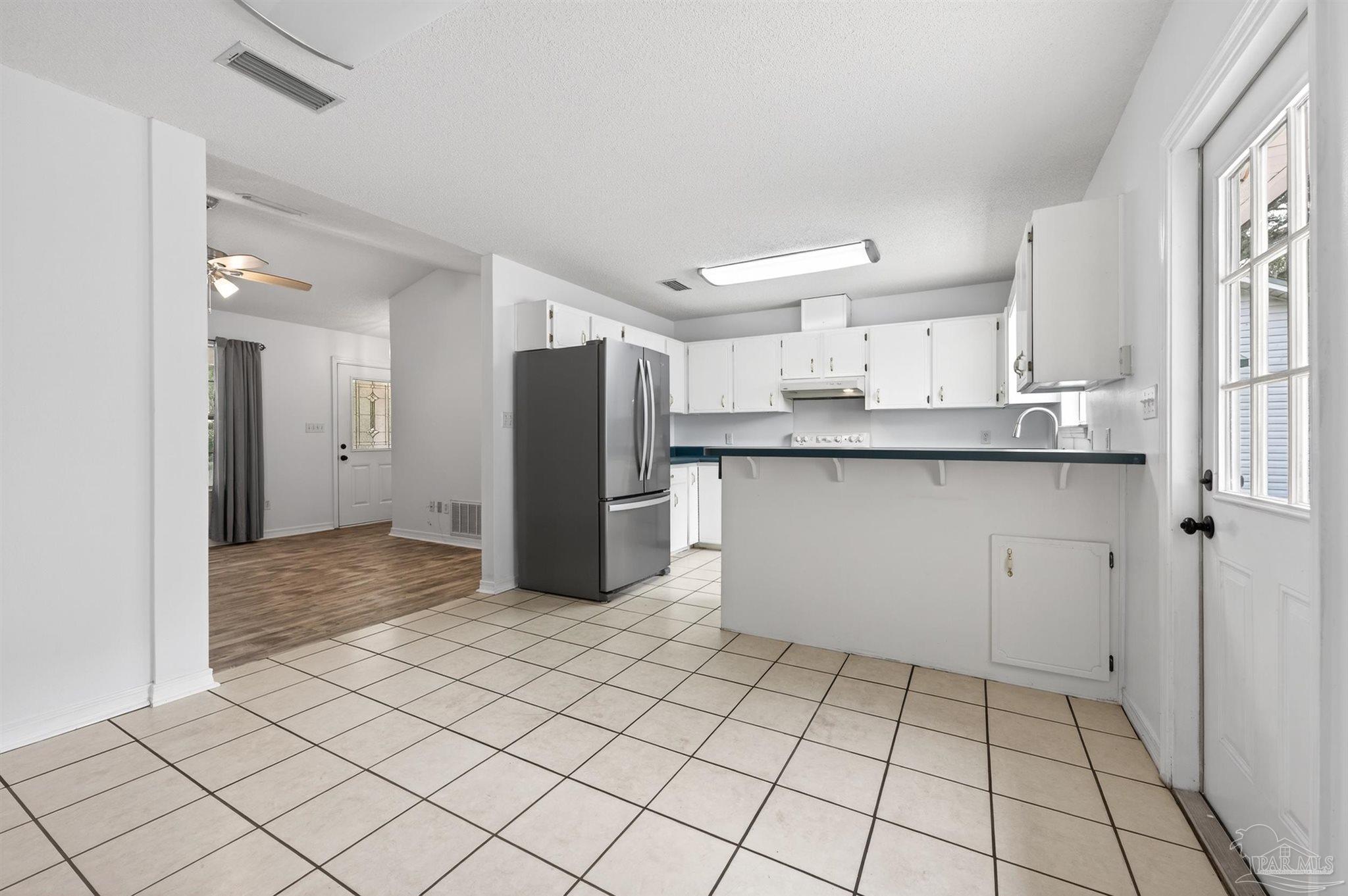 4885 Mayo Circle Pace, FL 32571 - Photo 13 of 44 a kitchen with stainless steel appliances a refrigerator and a sink