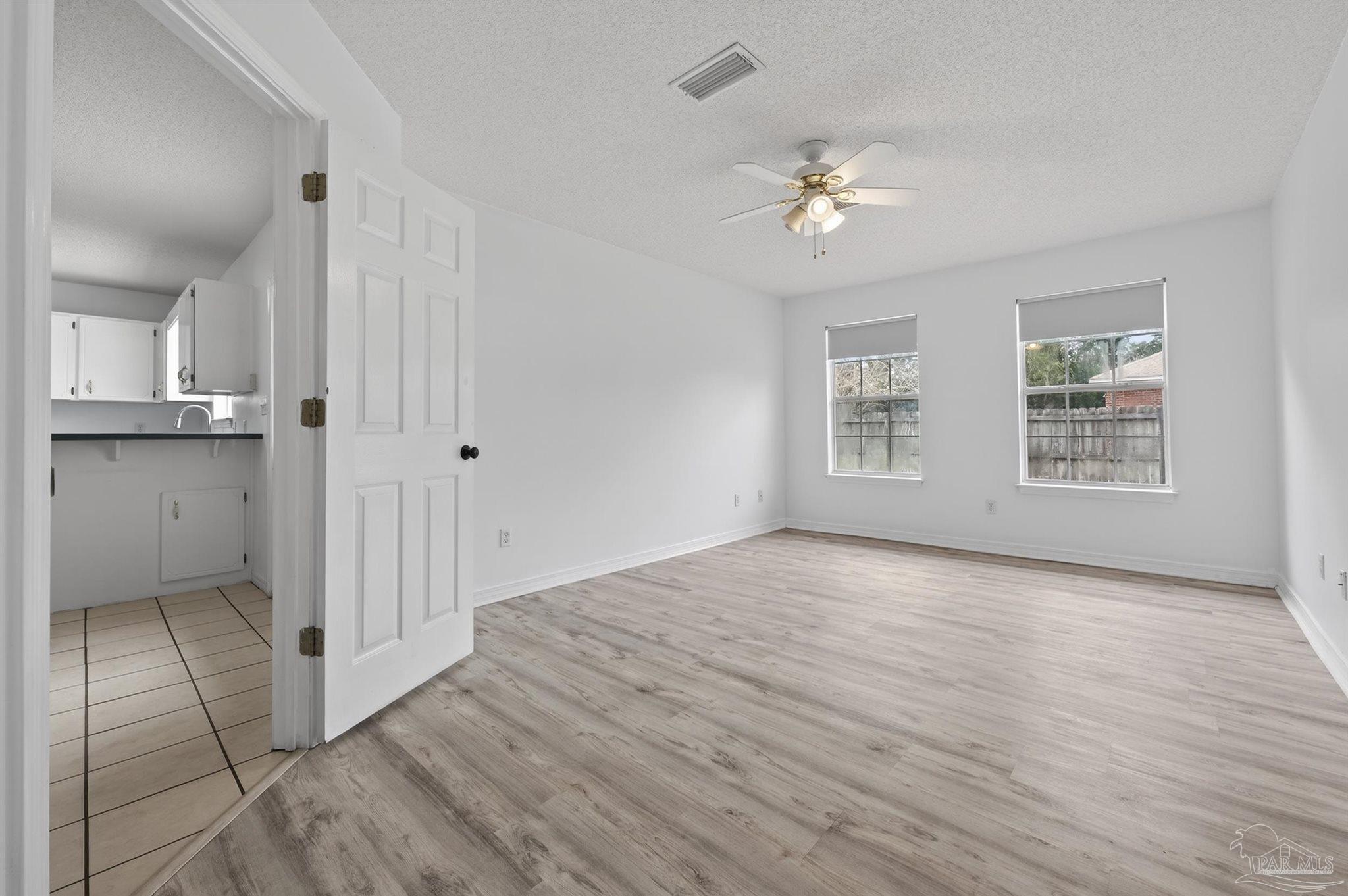 4885 Mayo Circle Pace, FL 32571 - Photo 15 of 44 wooden floor in an empty room with a window