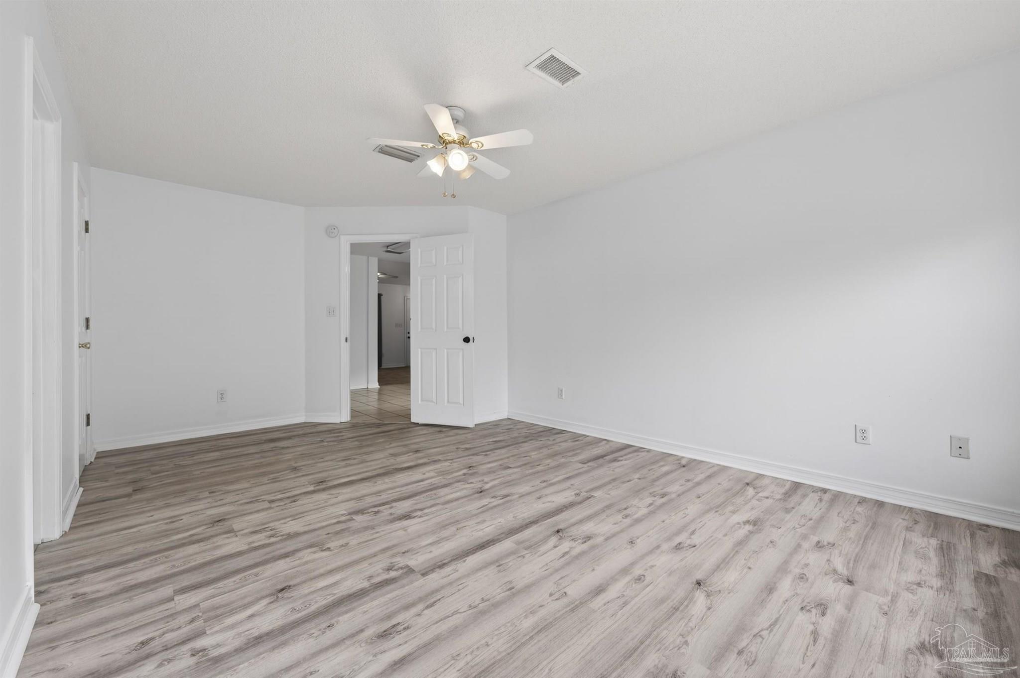 4885 Mayo Circle Pace, FL 32571 - Photo 17 of 44 a view of an empty room with wooden floor