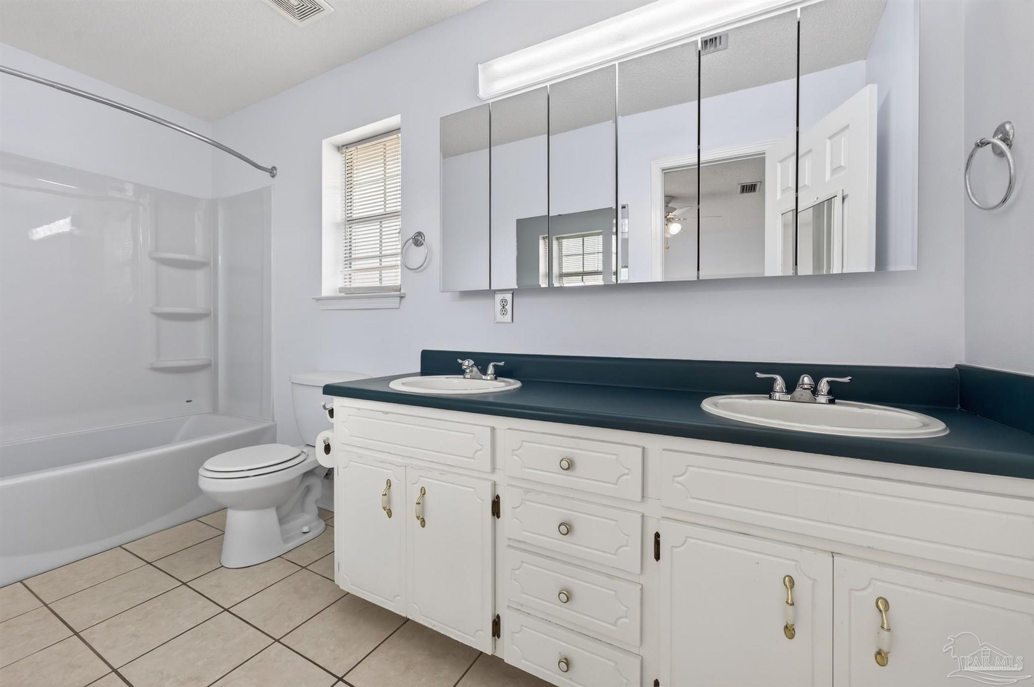 4885 Mayo Circle Pace, FL 32571 - Photo 19 of 44 a bathroom with a granite countertop sink a toilet and a bathtub