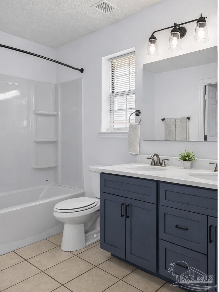 4885 Mayo Circle Pace, FL 32571 - Photo 20 of 44 a bathroom with a sink toilet a mirror and shower