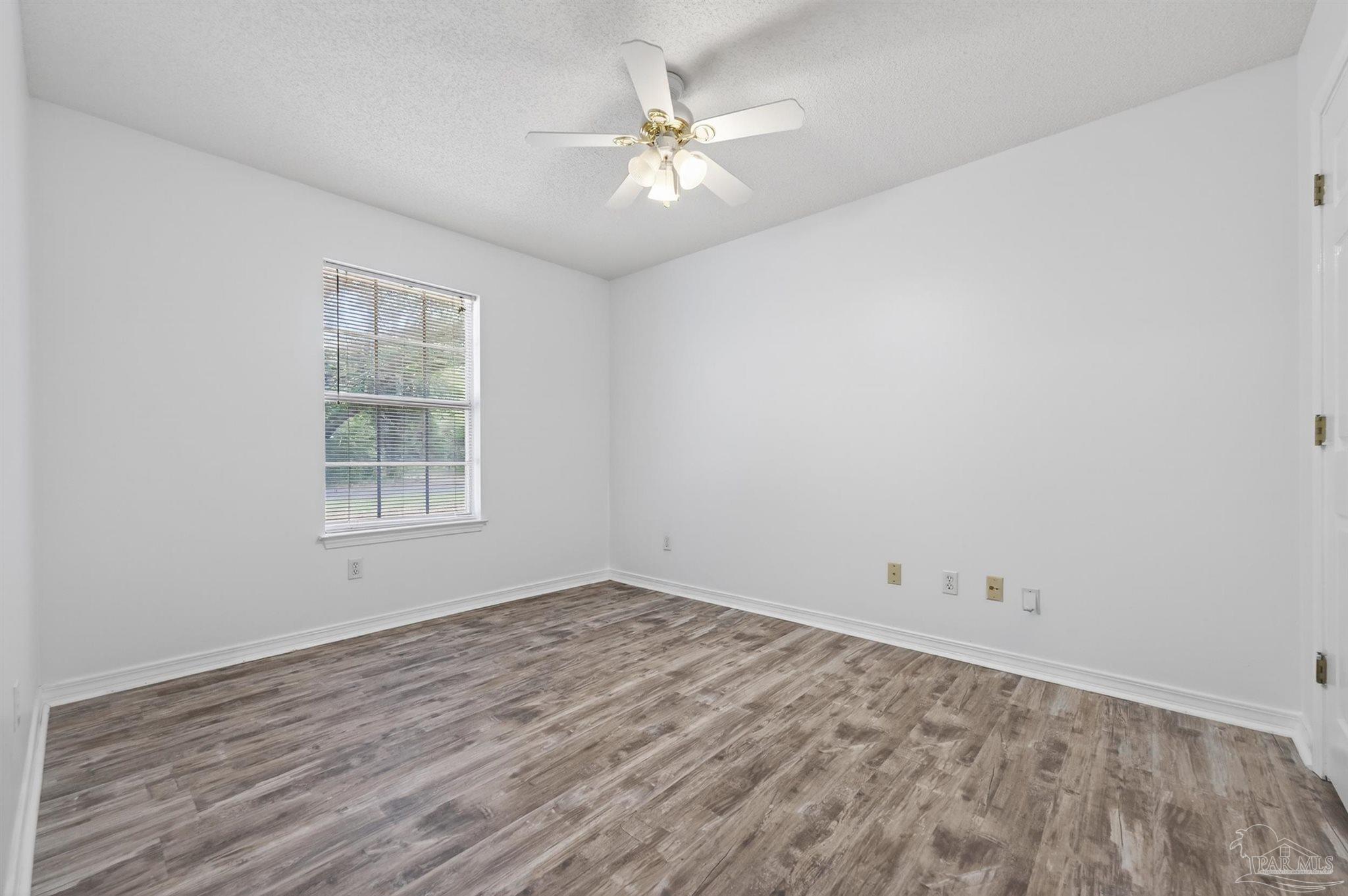4885 Mayo Circle Pace, FL 32571 - Photo 23 of 44 wooden floor in an empty room with a window