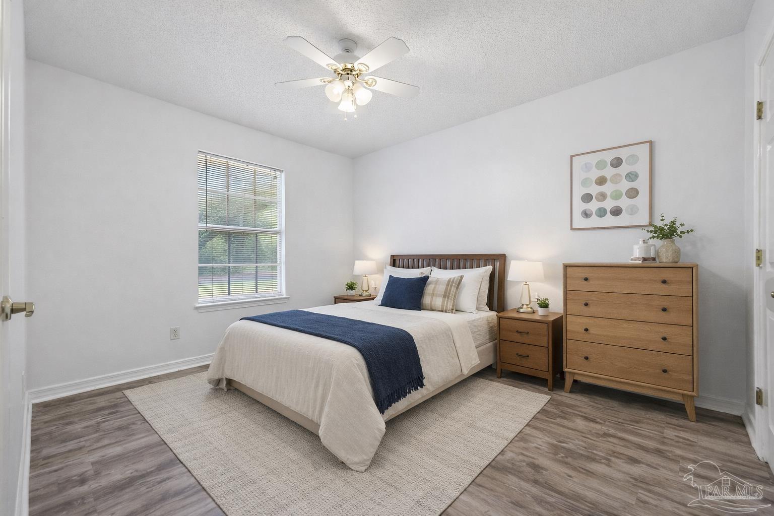 4885 Mayo Circle Pace, FL 32571 - Photo 24 of 44 a spacious bedroom with a bed and a window