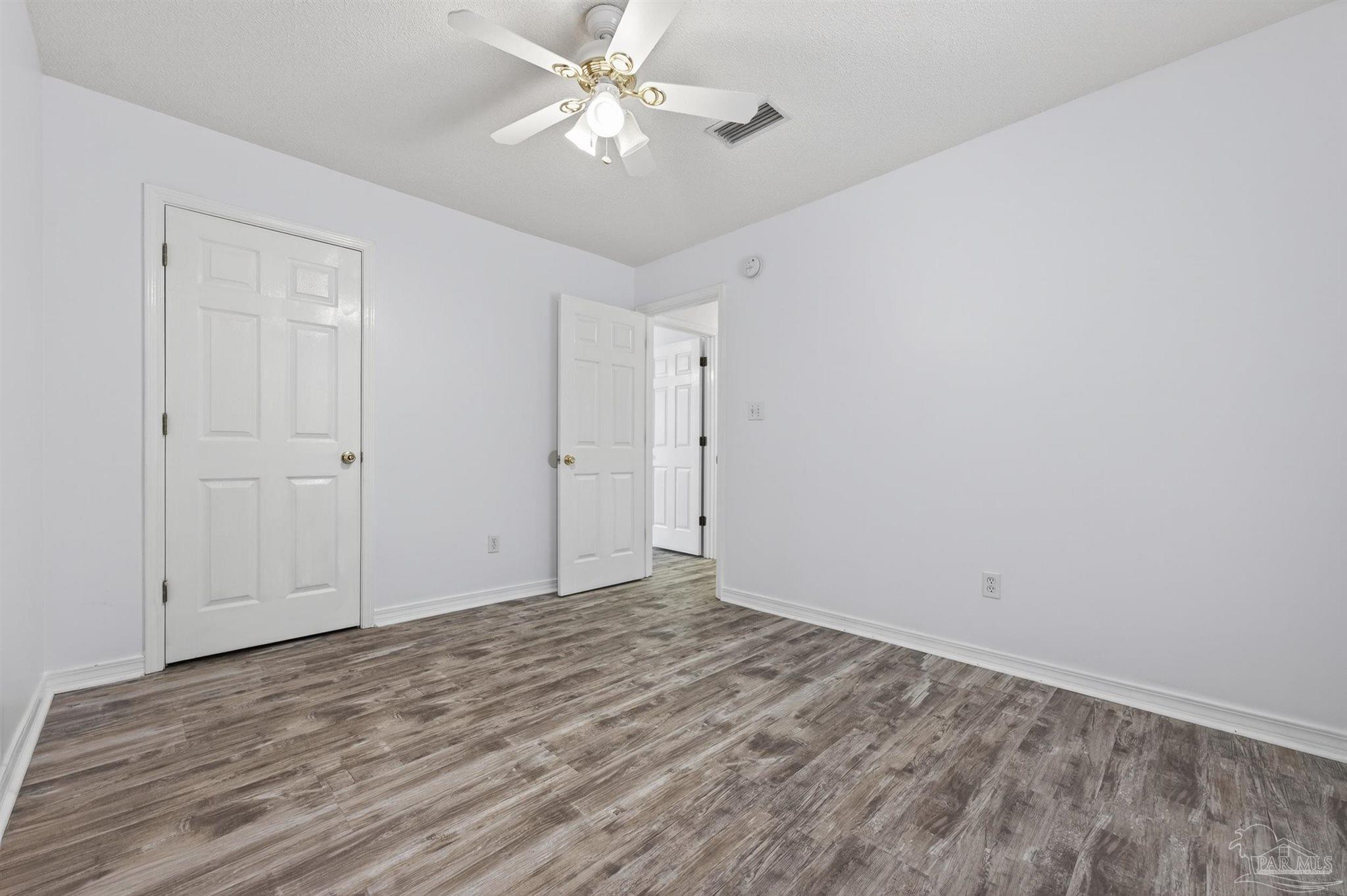 4885 Mayo Circle Pace, FL 32571 - Photo 25 of 44 a view of empty room with wooden floor