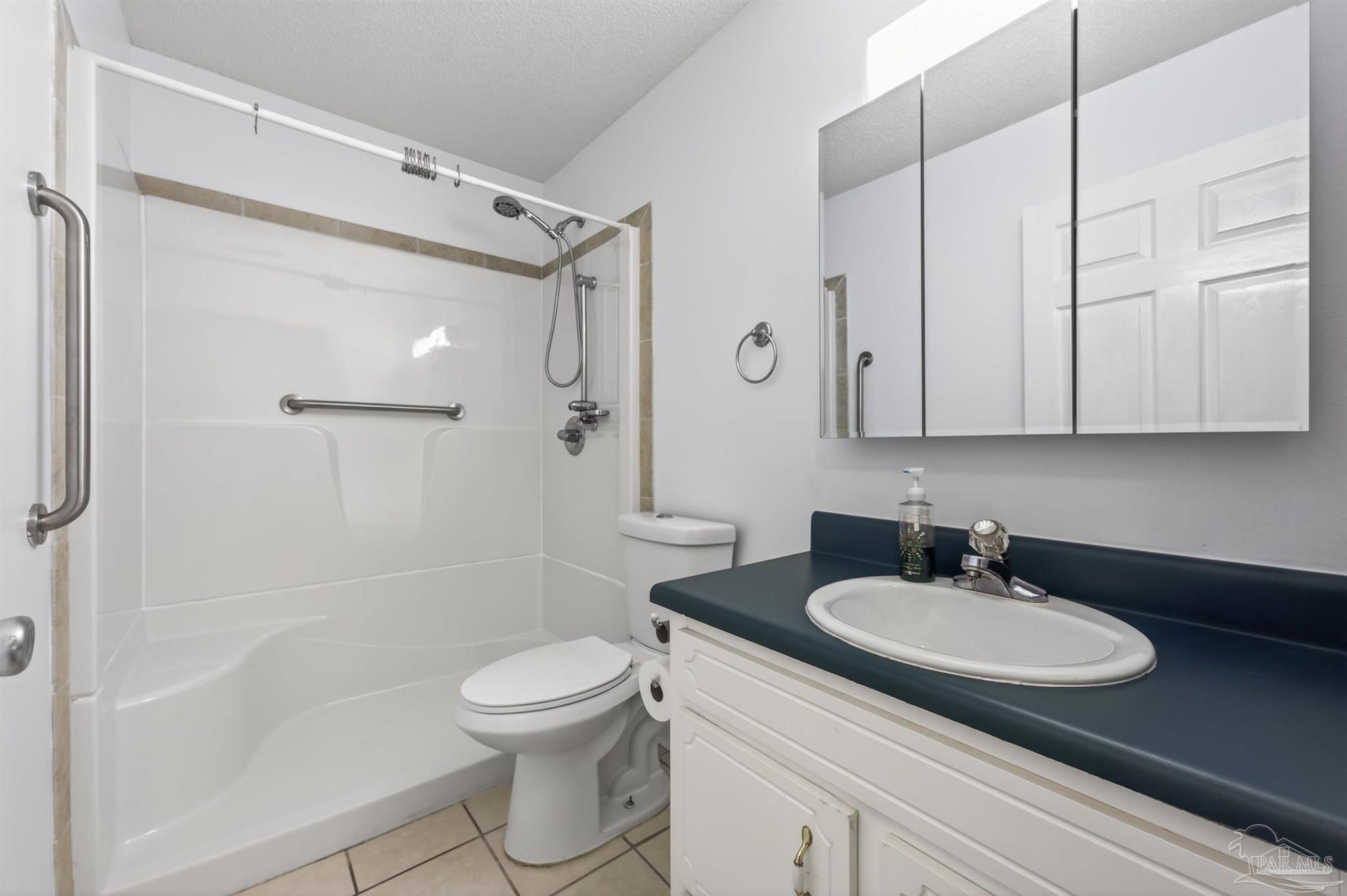 4885 Mayo Circle Pace, FL 32571 - Photo 26 of 44 a bathroom with a sink toilet a shower and a mirror