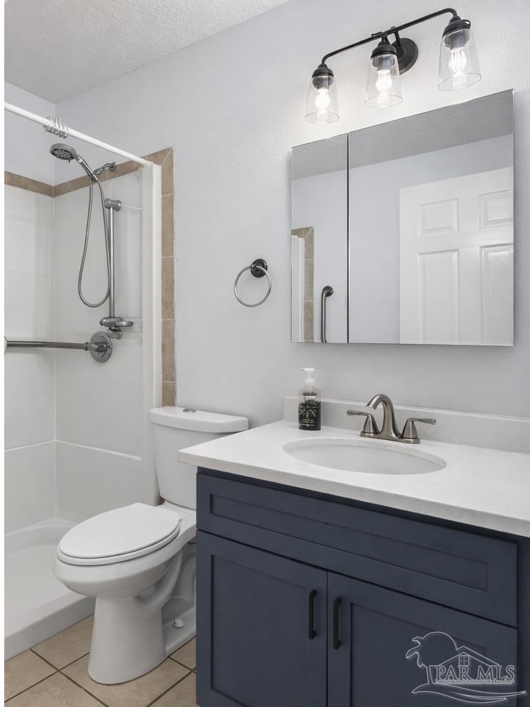 4885 Mayo Circle Pace, FL 32571 - Photo 27 of 44 a bathroom with a sink a toilet and shower