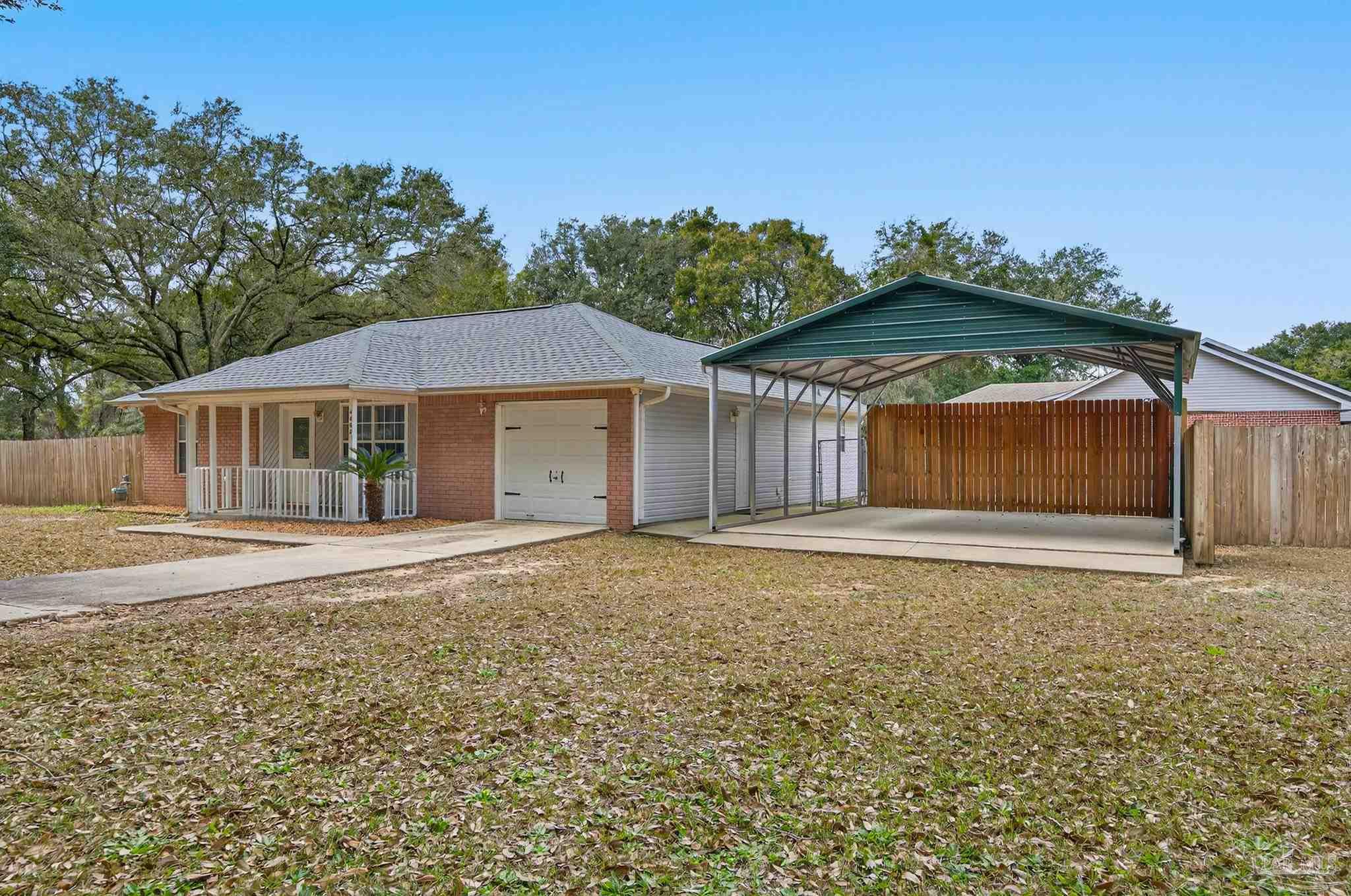 4885 Mayo Circle Pace, FL 32571 - Photo 3 of 44 a front view of a house with a yard