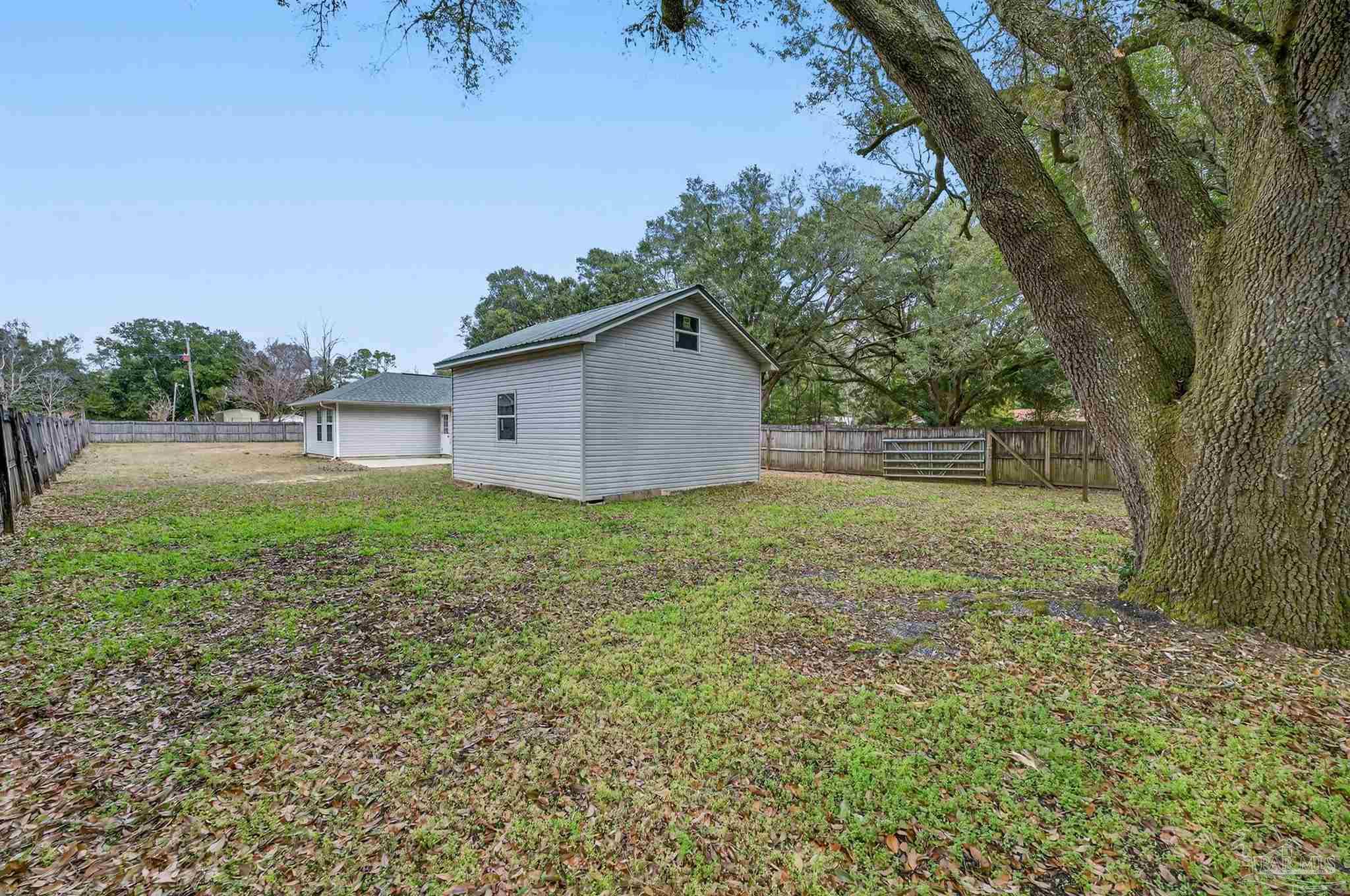 4885 Mayo Circle Pace, FL 32571 - Photo 34 of 44 a house view with a garden space