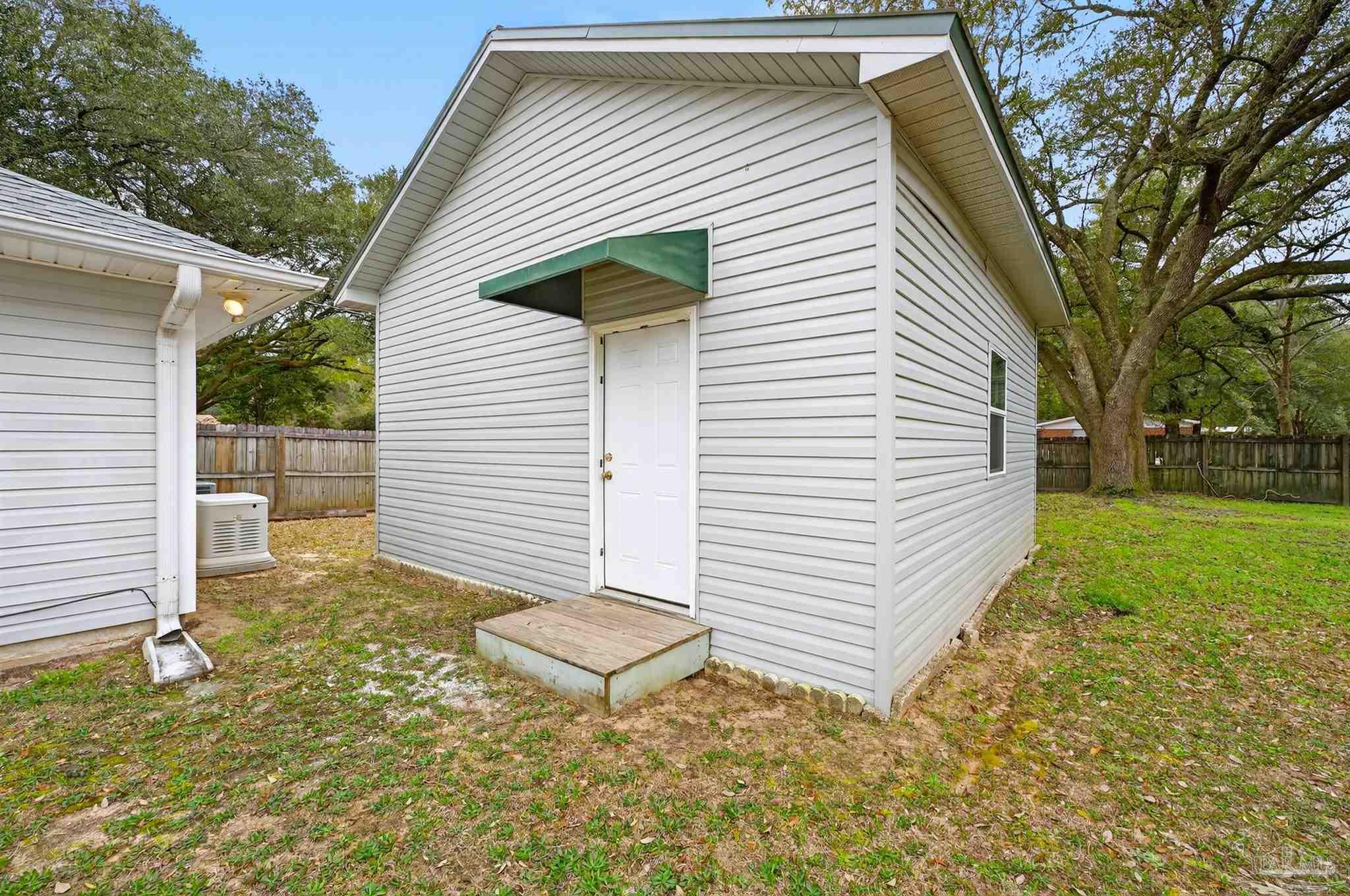 4885 Mayo Circle Pace, FL 32571 - Photo 36 of 44 a backyard of a house with garden and deck
