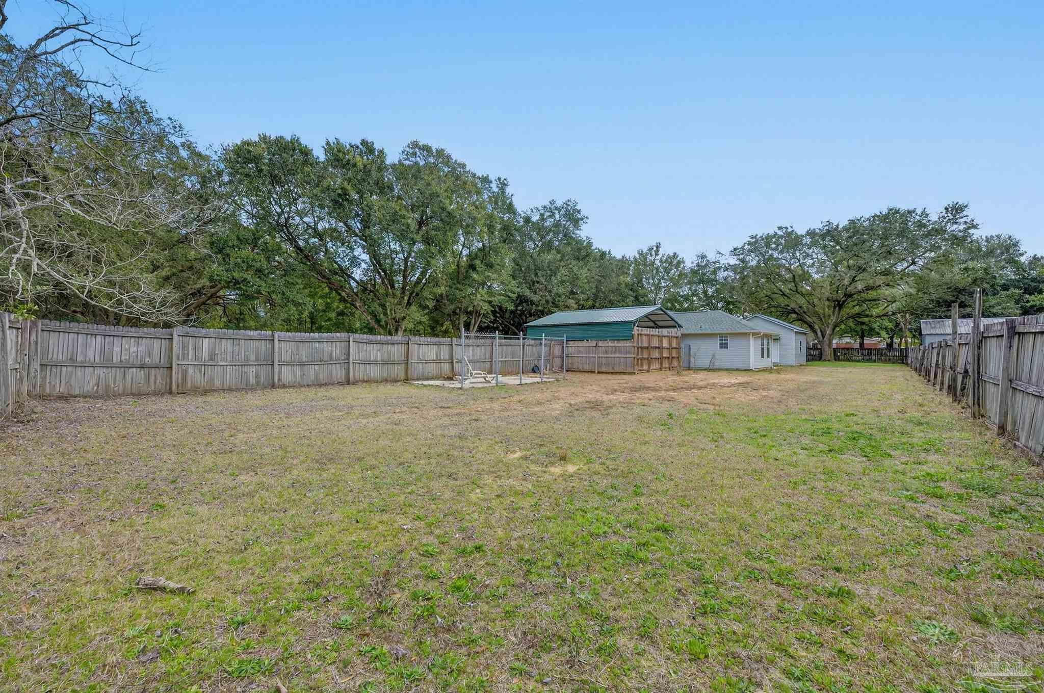 4885 Mayo Circle Pace, FL 32571 - Photo 44 of 44 a backyard of a house with lots of green space