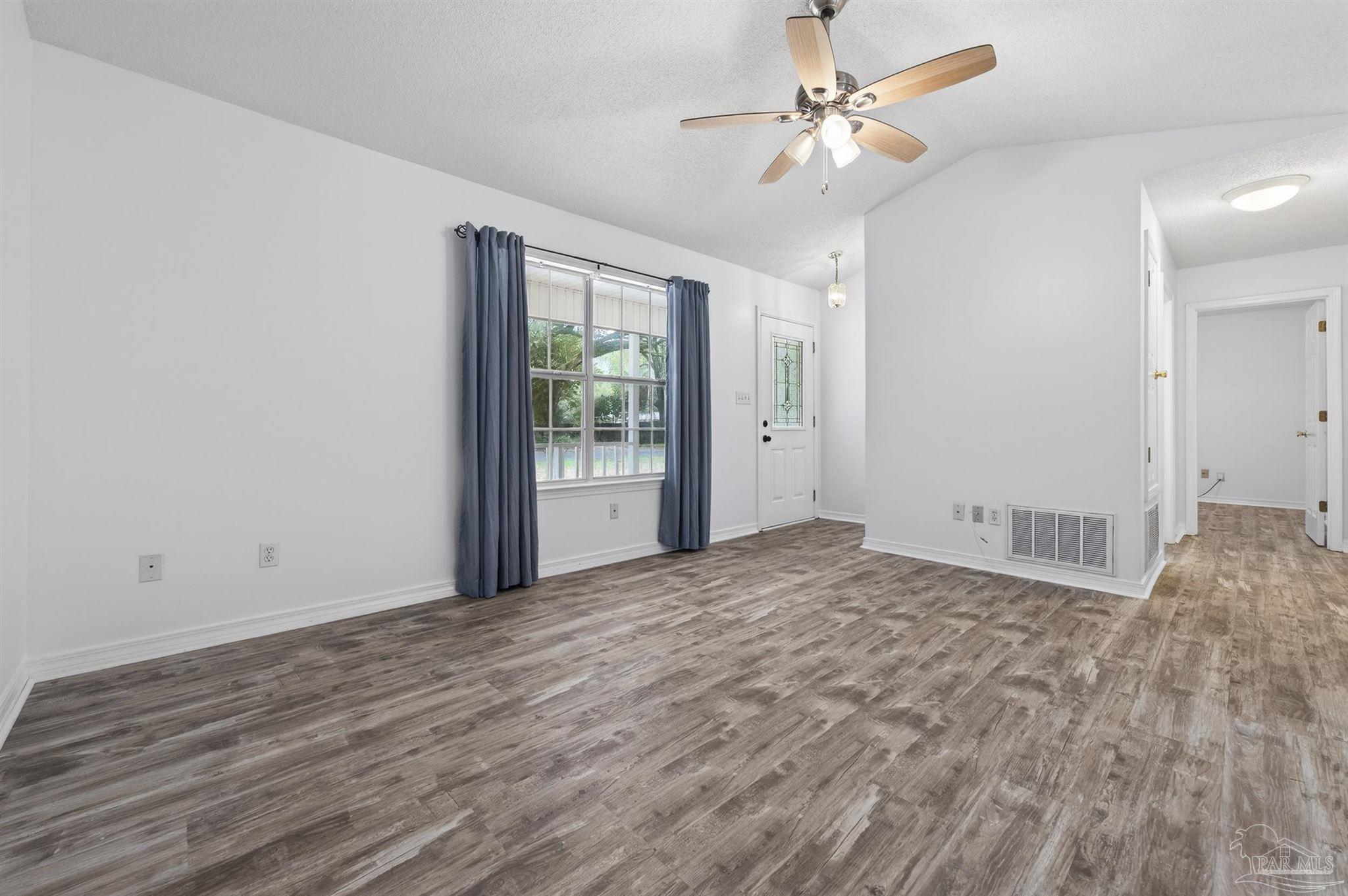 4885 Mayo Circle Pace, FL 32571 - Photo 5 of 44 a view of empty room with ceiling fan