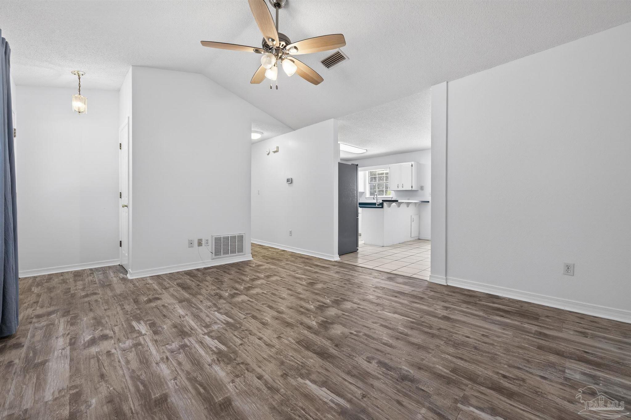 4885 Mayo Circle Pace, FL 32571 - Photo 6 of 44 a view of empty room with wooden floor and ceiling fan