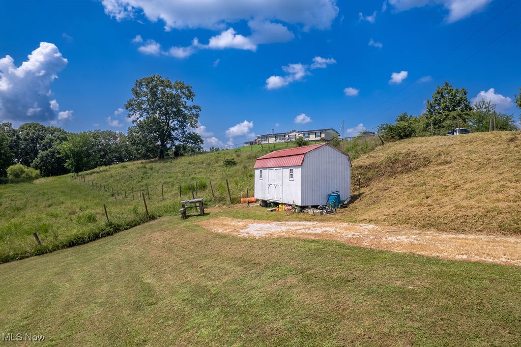 560 Wine Road Elizabeth, WV 26143 - Photo 40 of 50 View of green lawn with a storage shed and a view of rural / pastoral area