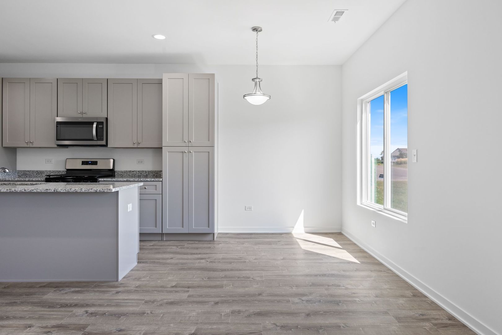 1236 Gillespie Lane Yorkville, IL 60560 - Photo 6 of 20 a kitchen with kitchen island white cabinets and refrigerator