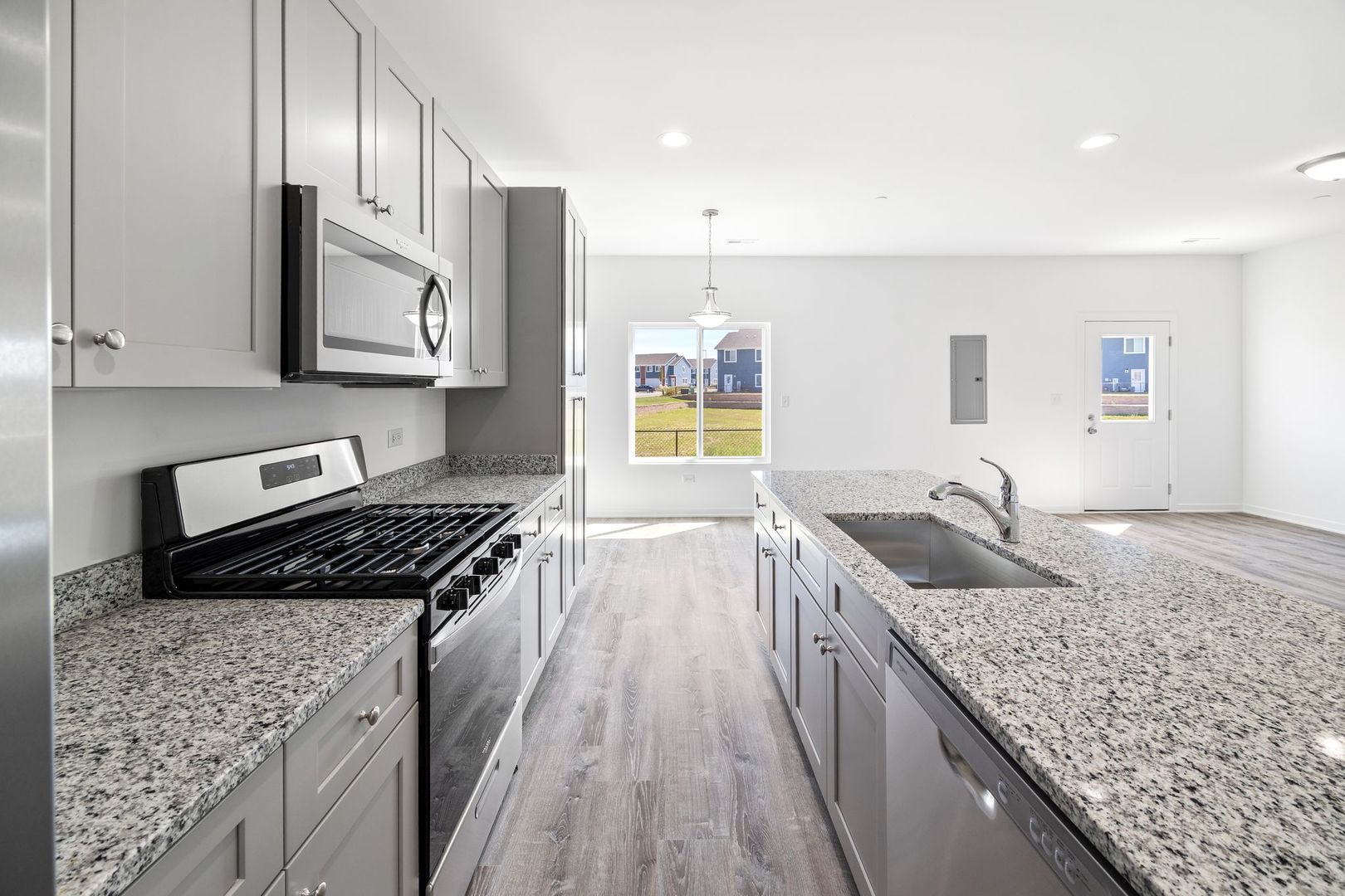 1236 Gillespie Lane Yorkville, IL 60560 - Photo 7 of 20 a kitchen with granite countertop stainless steel appliances window a sink and cabinets