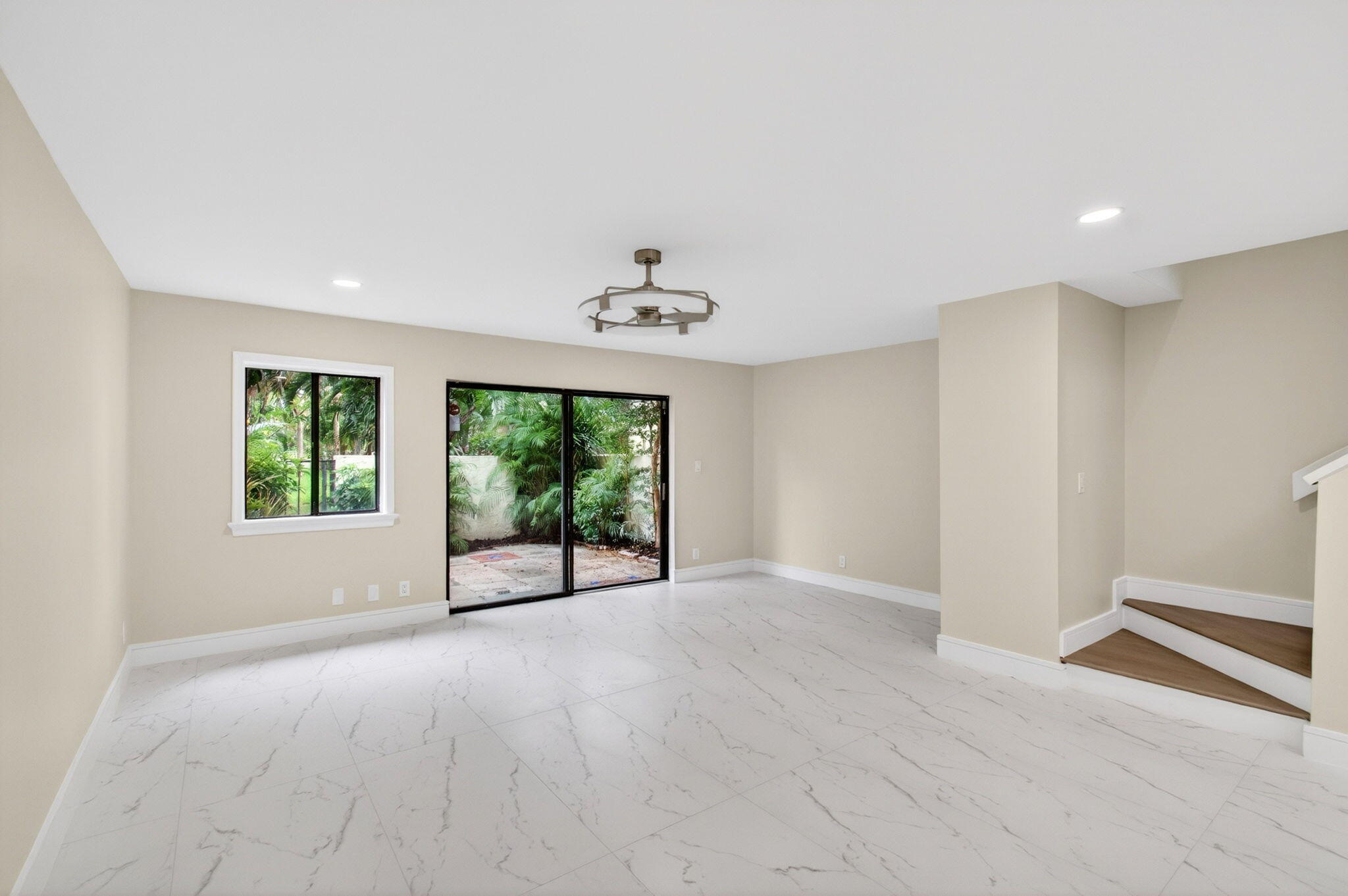1330 Northwest 13th Street, Unit 12 Boca Raton, FL 33486 - Photo 14 of 52 an empty room with windows and ceiling fan