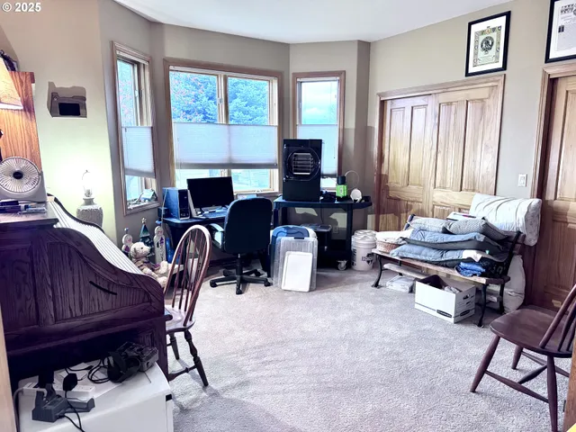a living room with furniture a fireplace and a window