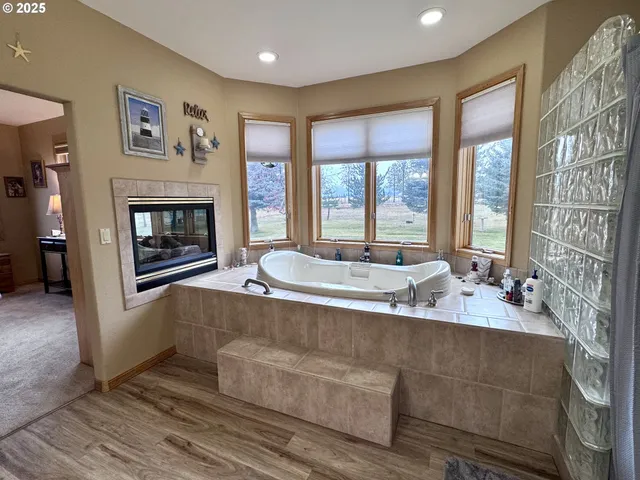 a living room with fireplace furniture and a large window