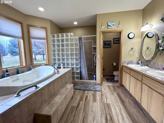 a large bathroom with a large tub and sink