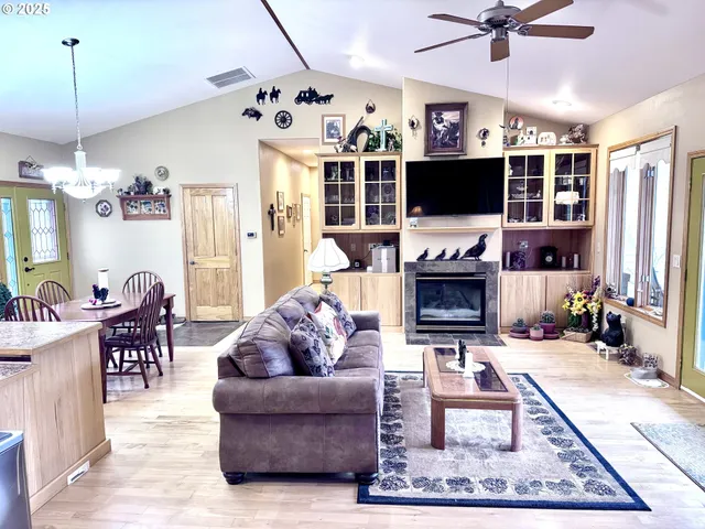 a living room with fireplace furniture and a flat screen tv