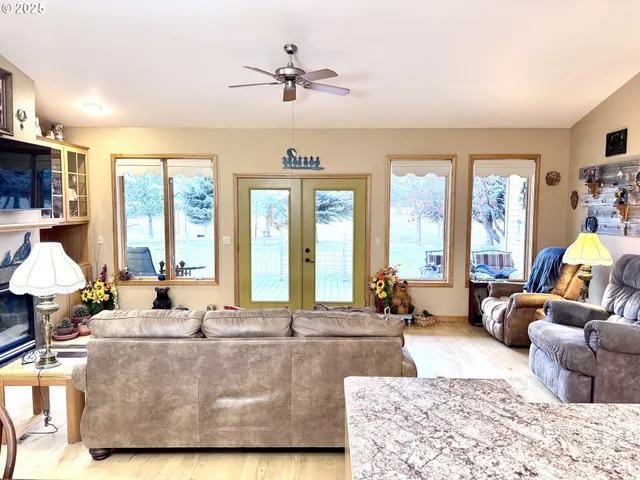 a living room with furniture and floor to ceiling windows