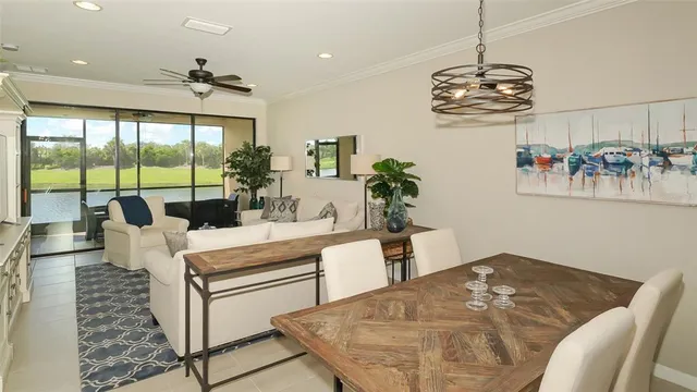 a kitchen with stainless steel appliances granite countertop a sink counter space and living room view