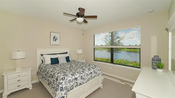 an aerial view of a swimming pool with a yard and lake view
